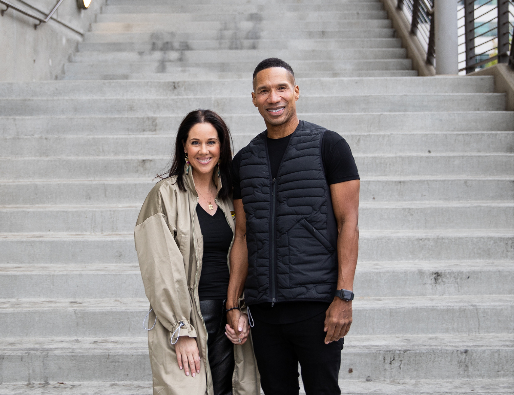 Man and Woman standing at the bottom of a cement staircase